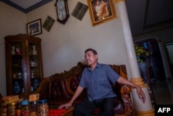 Sutaryo, owner of a home-based tempe chips industry, a traditional Indonesian food made from fermented soybeans and the chairman of the cooperative for Indonesian tofu tempe producers, talks to AFP at his house in Jakarta May 18, 2022.