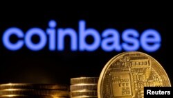 FILE: A representation of cryptocurrency is seen in front of Coinbase logo in this illustration taken on March 4, 2022.