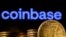 FILE: A representation of cryptocurrency is seen in front of Coinbase logo in this illustration taken on March 4, 2022.