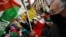 FILE - Demonstrators wave Western Sahara flags during a protest against the Spanish government support for Morocco's autonomy plan for Western Sahara, in Madrid, on March 26, 2022. 