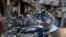 Ukrainian emergency service personnel work outside a damaged building following shelling, in Kharkiv, Ukraine, Saturday, June 4, 2022.