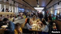 People visit the new restaurant "Vkusno & tochka", which opens following McDonald's Corp company's exit from the Russian market, in Moscow, June 12, 2022. 