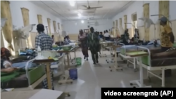 People and wounded victims of Sunday's attack at St. Francis Catholic Church in Owo, Ondo state, northwestern Nigeria, gather at St. Louis Catholic Hospital, June 5, 2022.