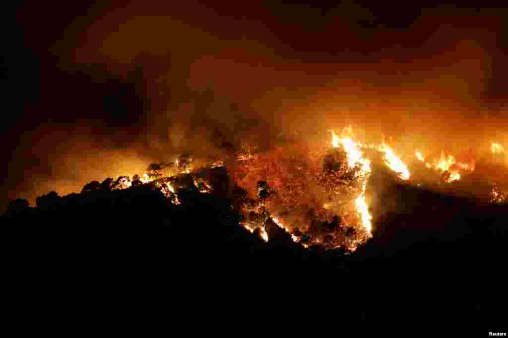 A forest fire is seen burning in Benahavis, Spain, June 8, 2022.