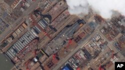 This satellite image from Planet Labs PBC shows construction of China's Type 003 aircraft carrier at the Jiangnan Shipyard northeast of Shanghai, China, May 21, 2022.