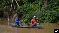 Two Indigenous men paddle on the Itaquai River searching for British journalist Dom Phillips and Indigenous affairs expert Bruno Araujo Pereira in the Javari Valley Indigenous territory, Atalaia do Norte, Amazonas state, Brazil, June 9, 2022.