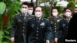 Chinese Minister of National Defense General Wei Fenghe heads to a bilateral meeting with U.S. Defense Secretary Lloyd Austin on the sidelines of the Shangri-La Dialogue in Singapore, June 10, 2022.