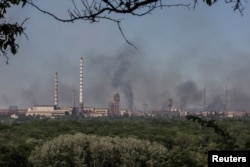 Smoke rises after a military strike on a compound of Sievierodonetsk's Azot Chemical Plant, amid Russia's attack on Ukraine, in the town of Lysychansk, Luhansk region, Ukraine, June 10, 2022.