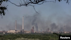 Smoke rises after a military strike on a compound of Sievierodonetsk's Azot Chemical Plant, amid Russia's attack on Ukraine, in the town of Lysychansk, Luhansk region, Ukraine, June 10, 2022. 