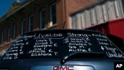 FILE - The names of the victims killed in last week's elementary school shooting are written on the back of an SUV near a memorial in Uvalde, Texas, June 3, 2022.
