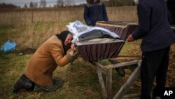 TƯ LIỆU - Nadiya Trubchaninova khóc bên quan tài của con trai bà, Vadym, bị sát hại vào ngày 30 tháng 3 bởi binh lính Nga ở Bucha, Ukraine, trong lễ tang của ông tại nghĩa trang Mykulychi gần đó, ngoại ô Kyiv, vào ngày 16 tháng 4 năm 2022.