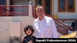 Business innovator Rick Caruso takes a picture with a young member of the Thai Communities during a meet and greets with Mayoral event at the Wat Thai of LA (Thai Temple of LA), May 2022.