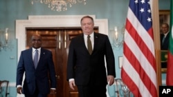 FILE - Former U.S. Secretary of State Mike Pompeo, right, arrives with Maldives Foreign Minister Abdulla Shahid, Feb. 20, 2019, at the Department of State in Washington. 
