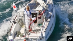 Japan's Kenichi Horie is seen on his sailing boat after his trans-Pacific sailing, at Osaka Bay, western Japan, Saturday, June 4, 2022. (Kyodo News via AP)