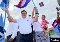 Vice President of Candlelight Party, Son Chhay, waves flags during a campaign rally for the upcoming local elections on June 5, in Phnom Penh, Cambodia May 21, 2022.