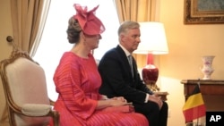 FILE - Belgium's King Philippe, right, and Queen Mathilde attend a meeting with the Greek President Katerina Sakellaropoulou and her partner Pavlos Kotsonis at the Presidential Palace in Athens, Greece, May 2, 2022.