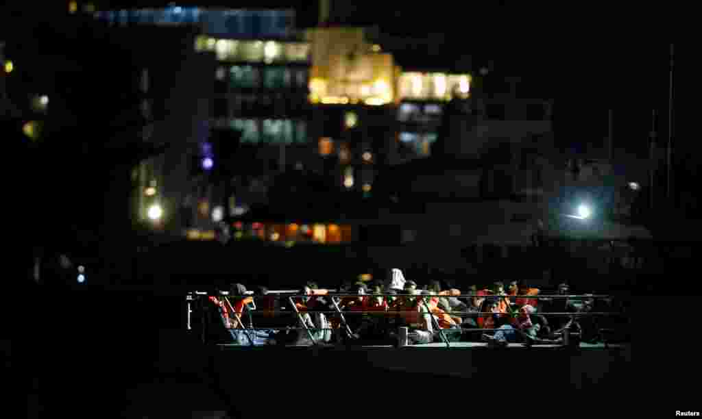 Migrants who were rescued by the Italian coastguard, arrive on an Armed Forces of Malta patrol boat in Valletta&#39;s Marsamxett Harbour, Malta, Sept. 17, 2019.