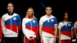 Athletes display the Olympic uniforms for Russian athletes in Moscow, April 14, 2021. The Olympic kit for the Tokyo Games, will not depict any symbols of the country.