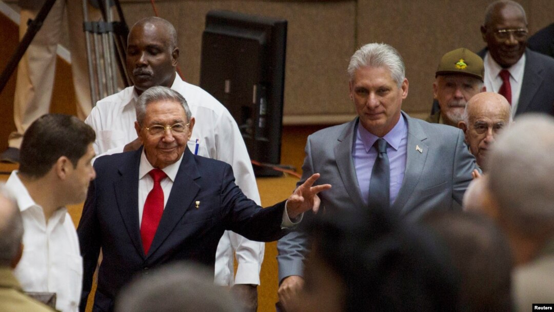 Cuba's President Raul Castro (C-L) and First Vice-President Miguel Diaz-Canel (C-R) arrive for a session of the National Assembly in Havana, Cuba, April 18, 2018. Diaz-Canel was named to succeed Castro Thursday.