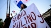 A demonstrator holds a sign as she takes part in a protest against the visit of U.S. Secretary of State Marco Rubio in Panama City on Jan. 30, 2025.