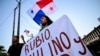 A demonstrator holds a sign as she takes part in a protest against the visit of U.S. Secretary of State Marco Rubio in Panama City on Jan. 30, 2025.