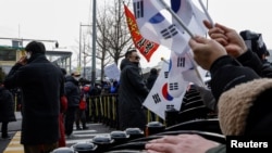 Pro-Yoon demonstrators shout slogans outside the official residence of impeached South Korean President Yoon Suk Yeol in Seoul