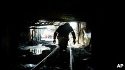 FILE - A miner walks out of a coal mine in Yukon, W.Va.