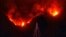 A photo provided by the Santa Barbara County Fire Department, with flames burning behind it, shows a lone Christmas tree standing in the front yard of an evacuated home in Carpinteria, Calif., Dec. 11, 2017. 
