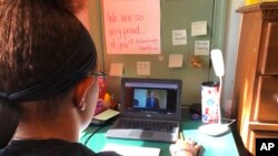 FILE - Katie Griffin, a junior at Norristown Area High School, takes part in virtual Spanish class at her home in Norristown, Pa., Sept. 3, 2020.