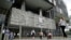 FILE - People walk in front of Brazilian oil company Petrobras's headquarters in Rio de Janeiro, Nov. 14, 2014.