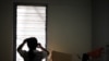 FILE - A refugee from Myanmar's ethnic Chin tribe looks out a window in an apartment housing more than 20 asylum-seekers in Kuala Lumpur, June 17, 2010. Ethnic Chin refugees from Myanmar protested Sept. 26, 2024, in Kuala Lumpur, accusing the UNHCR of abuse.