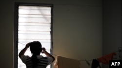 FILE - A refugee from Myanmar's ethnic Chin tribe looks out a window in an apartment housing more than 20 asylum-seekers in Kuala Lumpur, June 17, 2010. Ethnic Chin refugees from Myanmar protested Sept. 26, 2024, in Kuala Lumpur, accusing the UNHCR of abuse.