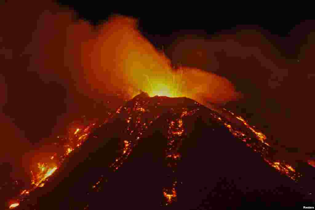 An eruption from Mount Etna lights up the sky during the night, seen from the small village of Fornazzo, Italy, Jan. 18, 2021.