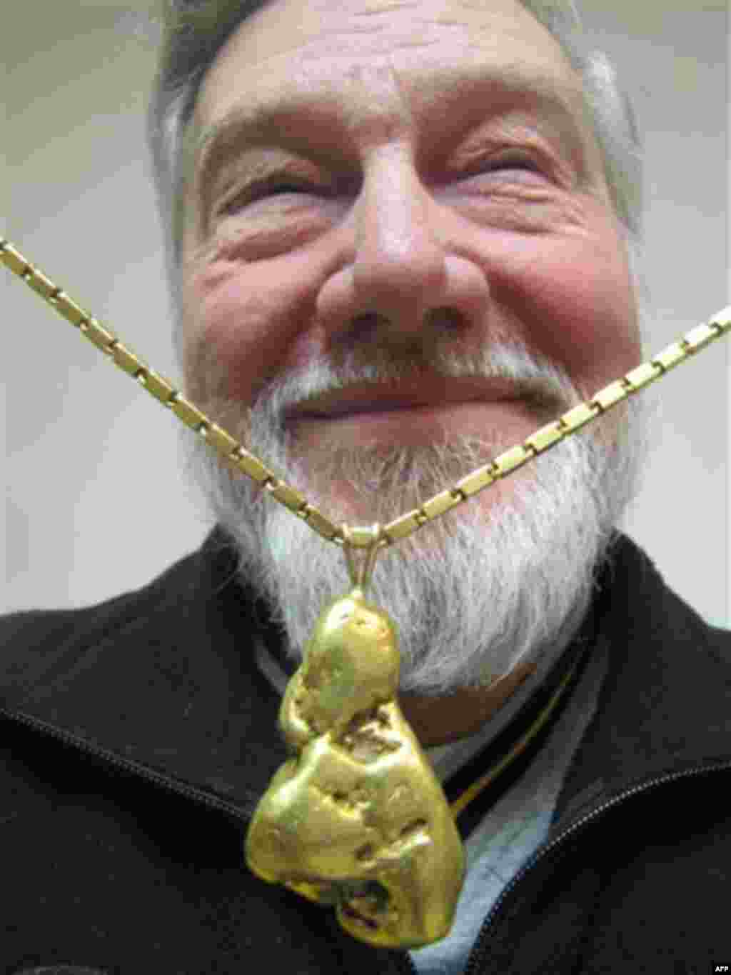 In this Nov. 17, 2011 photo, Bill Dunlevy poses in Anchorage, Alaska, with his prized find, a 5 ounce piece of gold he found while prospecting and turned into a necklace. Dunlevy says it's the lure of the gold, what he calls "gold fever" that causes him a