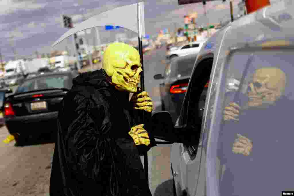 A Civil Protection employee participates in the campaign &quot;Beware of Monoxide, the Silent Killer&quot;, which seeks to prevent deaths from poisoning with carbon monoxide through the use of heaters to mitigate low temperatures, in Ciudad Juarez, Mexico, Feb. 2, 2022.