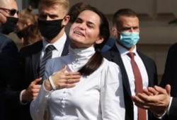 FILE - Belarusian opposition leader Sviatlana Tsikhanouskaya interacts with supporters in Warsaw, Poland, Sept. 9, 2020.