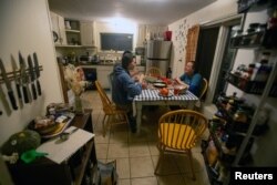 FILE - A group of islanders eat a lobster dinner together on Monhegan Island, ten miles off the coast of Maine, U.S., May 20, 2023. (REUTERS / Lauren Owens Lambert)