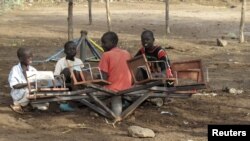 Sudanese children play with a broken playground chair in Kakuma refugee camp in Kenya. (File Photo)