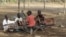 FILE - Children play with a broken playground chair in Kakuma refugee camp in northwestern Kenya. 
