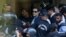 Security officers escort Pakistan's former Prime Minister Imran Khan as he appeared in Islamabad High Court