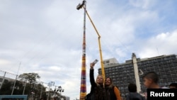 Beberapa pengunjung berswafoto di samping menara setinggi 36 meter sebagai upaya memecahkan rekor Guiness World untuk bangunan dari balok, di Tel Aviv, Israel, 27 Desember 2017.