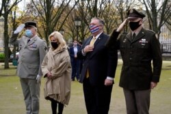 U.S. Secretary of State Mike Pompeo, second from right, pauses as he participates in a wreath-laying ceremony in homage to victims of terrorism at Les Invalides in Paris, Nov. 16, 2020.