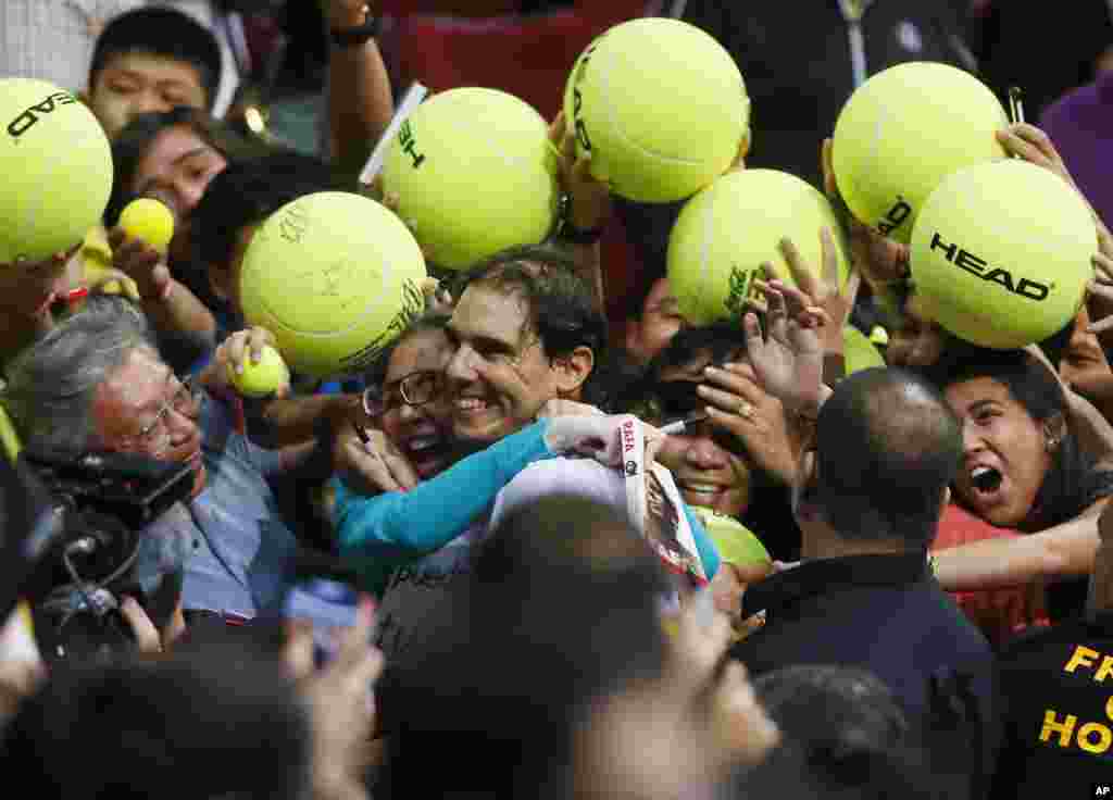 Spain&#39;s Rafael Nadal of the Indian Aces is mobbed by his Filipino fans following his win over the Czech Republic&rsquo;s Tomas Berdych of the UAE Royals in the men&#39;s singles of the 2015 International Premier Tennis League at the Mall of Asia Arena in suburban Pasay city, south of Manila, the Philippines.
