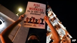 An activist holds a slogan outside the headquarters of broadcast network ABS-CBN corp. on Tuesday, May 5, 2020 in Quezon city, Metro Manila, Philippines. A Philippine government agency has ordered the country's leading broadcast network, which the…