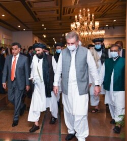Taliban political affairs chief Mullah Abdul Ghani Baradar, center, heads for talks with Foreign Minister Shah Mehmood Qureshi, right, and Pakistani spy agency ISI chief Lt. Gen Faiz Hameed, left, in Islamabad, Aug. 25, 2020. (Courtesy photo)