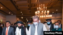 Taliban political affairs chief Mullah Abdul Ghani Baradar, center, heads for talks with Foreign Minister Shah Mehmood Qureshi, right, and Pakistani spy agency ISI chief Lt. Gen Faiz Hameed, left, in Islamabad, Aug. 25, 2020. (Photo courtesy of Pakistan F