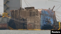 The sunken ferry Sewol is seen during its salvage operations on the sea off Jindo, South Korea, March 24, 2017. 