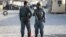 Afghan policemen keep watch at the site of an attack after an overnight battle outside a base in Kabul, Afghanistan, Aug. 8, 2015. 
