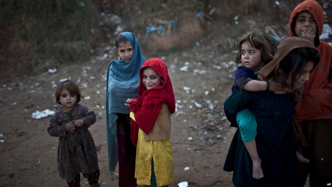Afghan refugee children are seen in a slum on the outskirts of Islamabad, Pakistan, Jan. 14, 2015.