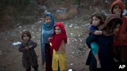 Afghan refugee children are seen in a slum on the outskirts of Islamabad, Pakistan, Jan. 14, 2015.